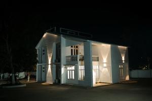 a white house at night with its lights on at Lighthouse Villa Homestay in Dimapur