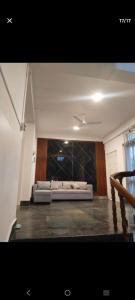 a living room with a couch and a ceiling at Lighthouse Villa Homestay in Dimapur +4 photos