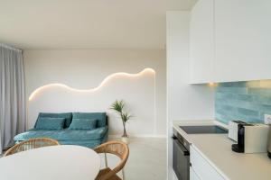 a kitchen and a living room with a couch at Albir Experience in Albir +115 photos