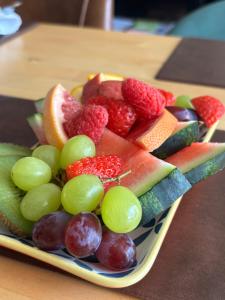 a plate filled with fruit on a table at Kelston Guest House in Weymouth