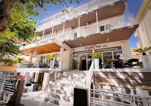 a building with stairs leading up to a restaurant at chiAma Hotel in Rimini