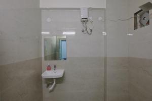 a white bathroom with a sink and a mirror at Slackpackr Malakpet Hyderabad in Hyderabad +40 photos