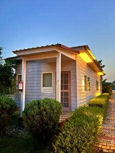 a small house with a sign on the side of it at Corbett VEDA INN in Rāmnagar