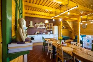 a dining room with a table and a kitchen at DejaView Cabin&Camp in Rogojel