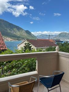 a balcony with chairs and a view of the water at Apartments Vukasović in Kotor