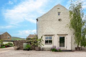 a stone cottage with a bench in front of it at 2 Bed in Bishop Auckland oc-93111 in Westgate