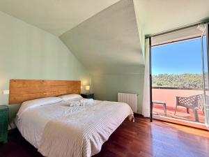 a bedroom with a bed and a large window at Casa Mirador del Pas - Monabri in Boó de Piélagos +31 photos