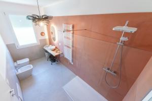 a bathroom with a shower and a toilet and a sink at In Riva in Cavallino-Treporti +25 photos