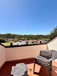 a balcony with a chair and a table and a view at Casa Mirador del Pas - Monabri in Boó de Piélagos