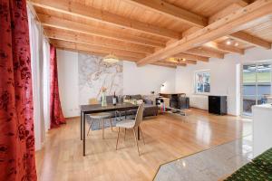 a dining room and living room with a table and chairs at Charming Lakenear Apartment in Sipplingen