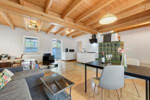 a living room with a couch and a table at Charming Lakenear Apartment in Sipplingen +18 photos