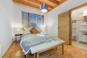 a bedroom with a large bed and a bathroom at Charming Lakenear Apartment in Sipplingen