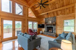 a living room with couches and a fireplace at Chasing Clouds Cabin in Todd