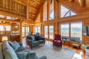 a living room with a couch and chairs in a cabin at Chasing Clouds Cabin in Todd