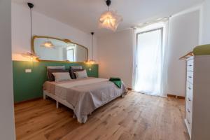 a bedroom with a bed and a large mirror at In Riva in Cavallino-Treporti