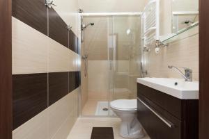 a bathroom with a shower and a toilet and a sink at Zwierzyńscy Residence in Pobierowo +52 photos