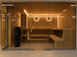 a room with a glass wall with a bench at St. Panteleimon Beach Hotel in Nesebar +126 photos