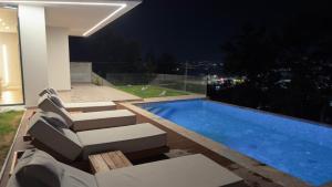 a view of a swimming pool at night at Panorama Hill Villa Tirana - Private Pool & Views in Tirana