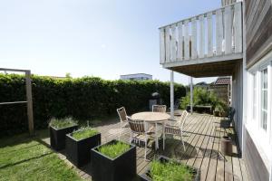 a patio with a table and chairs on a deck at id123 Karl Andersensvej 16 in Esbjerg +5 photos