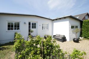 a white house with a couch in a yard at id123 Karl Andersensvej 16 in Esbjerg