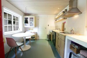 a small kitchen with a table and chairs in it at id123 Karl Andersensvej 16 in Esbjerg