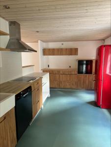 a kitchen with a red refrigerator and wooden cabinets at id123 Karl Andersensvej 16 in Esbjerg
