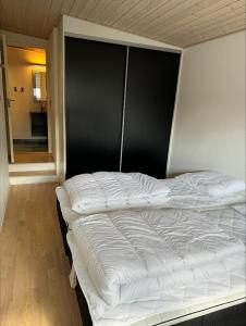 a white bed in a room with a window at id123 Karl Andersensvej 16 in Esbjerg