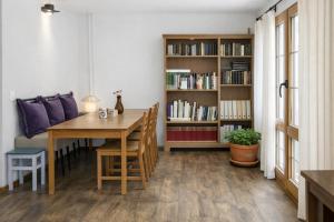 a dining room with a table and a book shelf at Casa La Farrapona Torrestío Babia in Torrestío +15 photos