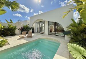 a swimming pool in the backyard of a house at The Young Villas - 1 Bedroom Villas, Bingin in Uluwatu