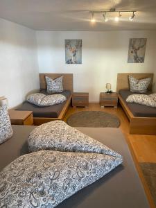 a room with three beds and a couch at Apartment Lärchenstube in Mieders