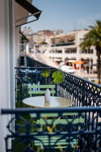 a table on a balcony with a plant on it at Crisol Lumière in Cannes