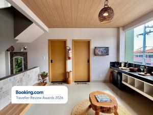 a living room with a table and a kitchen at Your Home - Studios Boutique Hotel in São Luís