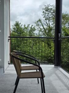 a bench sitting on the porch of a building at Alex in Castlerea
