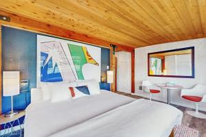 ein Schlafzimmer mit einem großen weißen Bett und einer Holzdecke in der Unterkunft Point Perfect in Port Madison