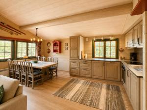 a kitchen and dining room with a table and chairs at Briskebu, cosy cabin by ski slopes in Geilo +12 photos
