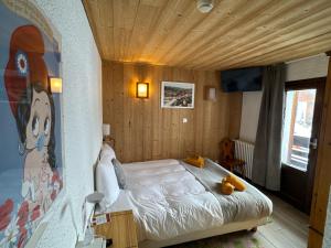 a bedroom with a bed with teddy bears on it at Logis Hôtel Le Cairn in Les Deux Alpes