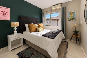 a bedroom with a large bed and a window at Ballito Zimbali Wedge in Ballito +26 photos
