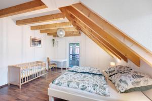 a bedroom with a bed and a crib at Ferienwohnung Joosenhof in Winden im Elztal