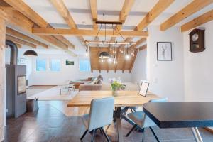 a dining room and living room with a table and chairs at Ferienwohnung Joosenhof in Winden im Elztal +18 photos