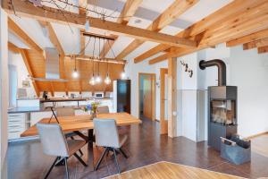 a kitchen and dining room with a wooden table and chairs at Ferienwohnung Joosenhof in Winden im Elztal
