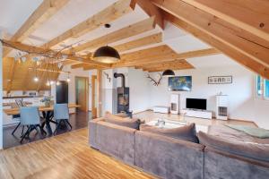 a living room with a couch and a dining room at Ferienwohnung Joosenhof in Winden im Elztal