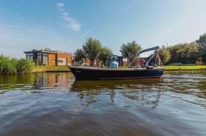 a group of people in a boat on the water at Velthorst 6 in Warmond