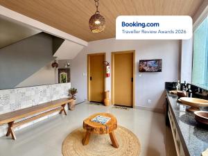 a living room with a bench and a table at Your Home - Studios Boutique Hotel in São Luís
