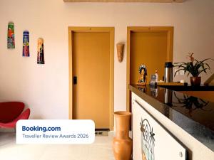 a kitchen with two doors and a counter top at Your Home - Studios Boutique Hotel in São Luís