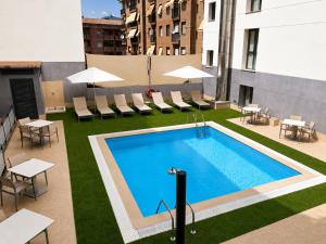 a swimming pool on top of a building at Hotel Pedro I de Aragón 4 Sup in Huesca