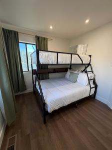 a bedroom with two bunk beds and a window at Two Trees Retreat in Salt Lake City