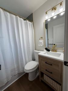 a bathroom with a toilet and a sink and a mirror at Two Trees Retreat in Salt Lake City +48 photos