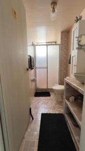 a small bathroom with a shower and a toilet at Rodadero Oasis in Santa Marta