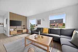 a living room with a couch and a table at Family Holiday Home with Jacuzzi and Fireplace in Hejls
