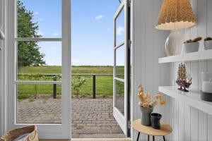 a door leading to a patio with a view of a field at Family Holiday Home with Jacuzzi and Fireplace in Hejls